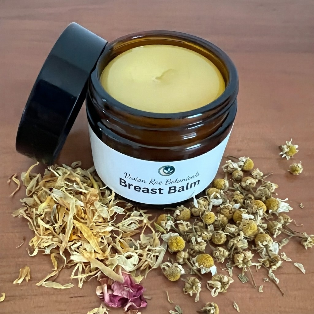 Open jar of Breast Balm with dried calendula petals and chamomile flowers