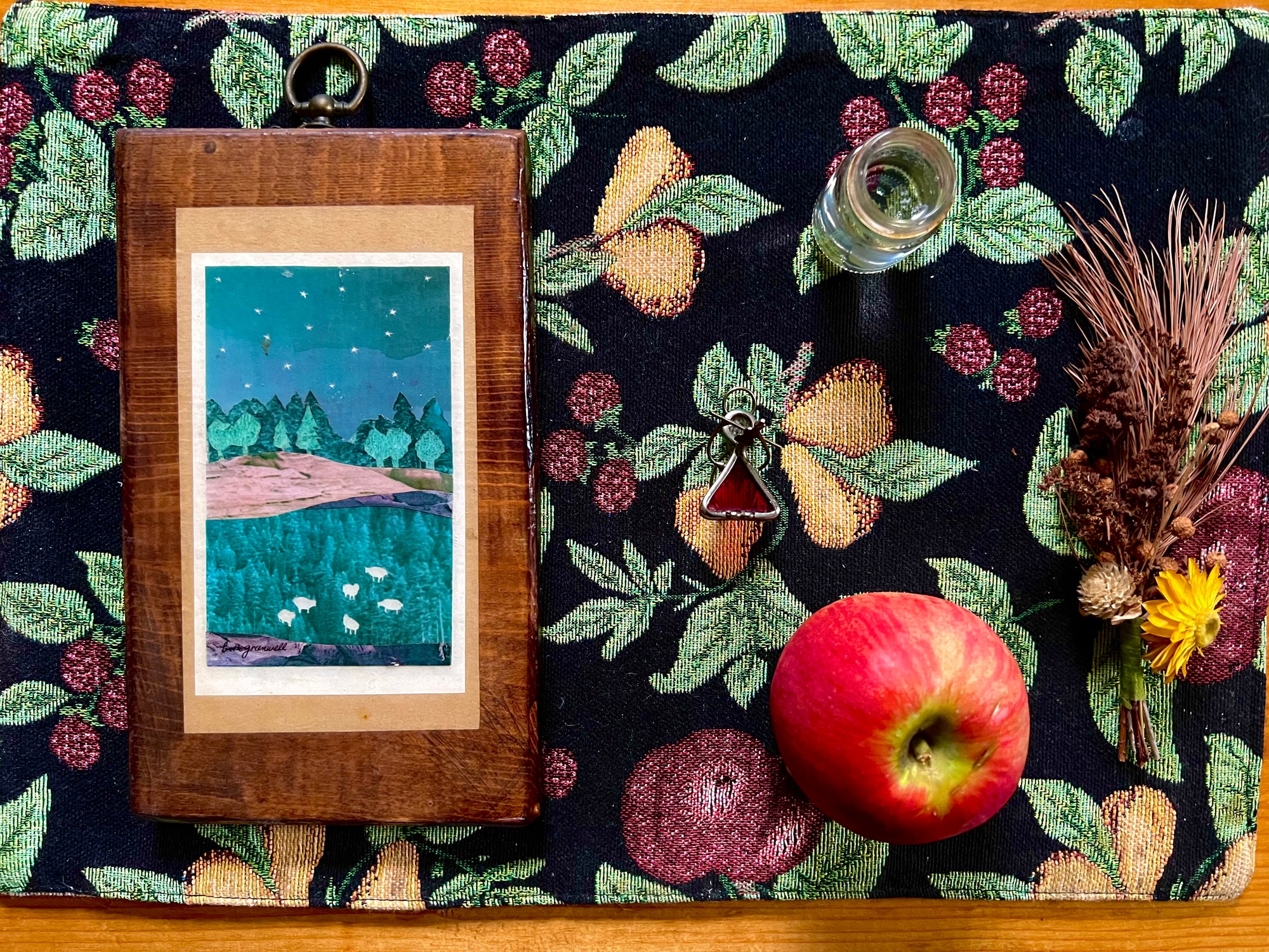 Ancestor altar with a small painting, a jar of water, an apple and dried flowers