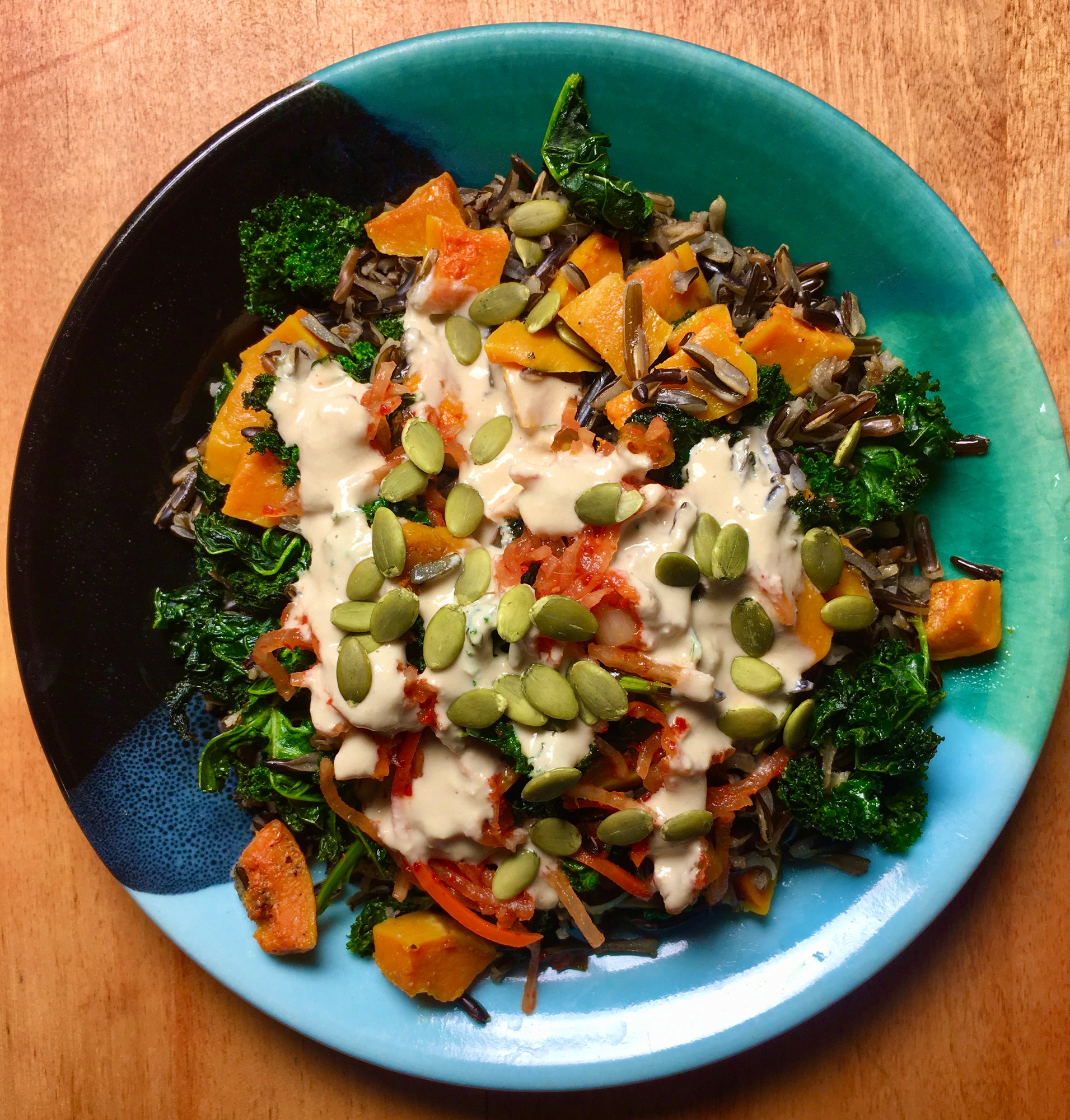 Wild rice, kale and roasted squash with pumpkin seeds and a creamy sauce