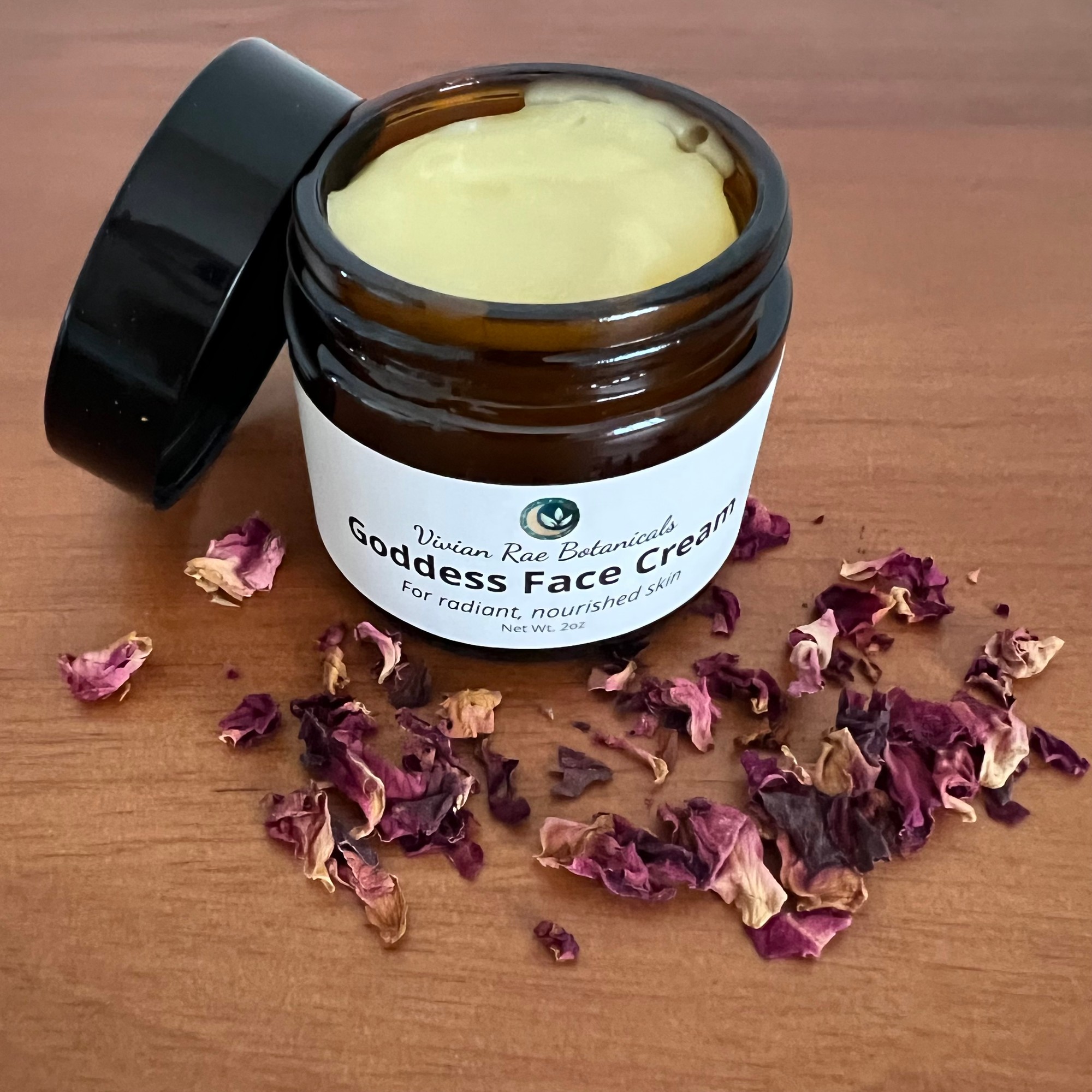 Open jar of Goddess Face Cream with dried rose petals