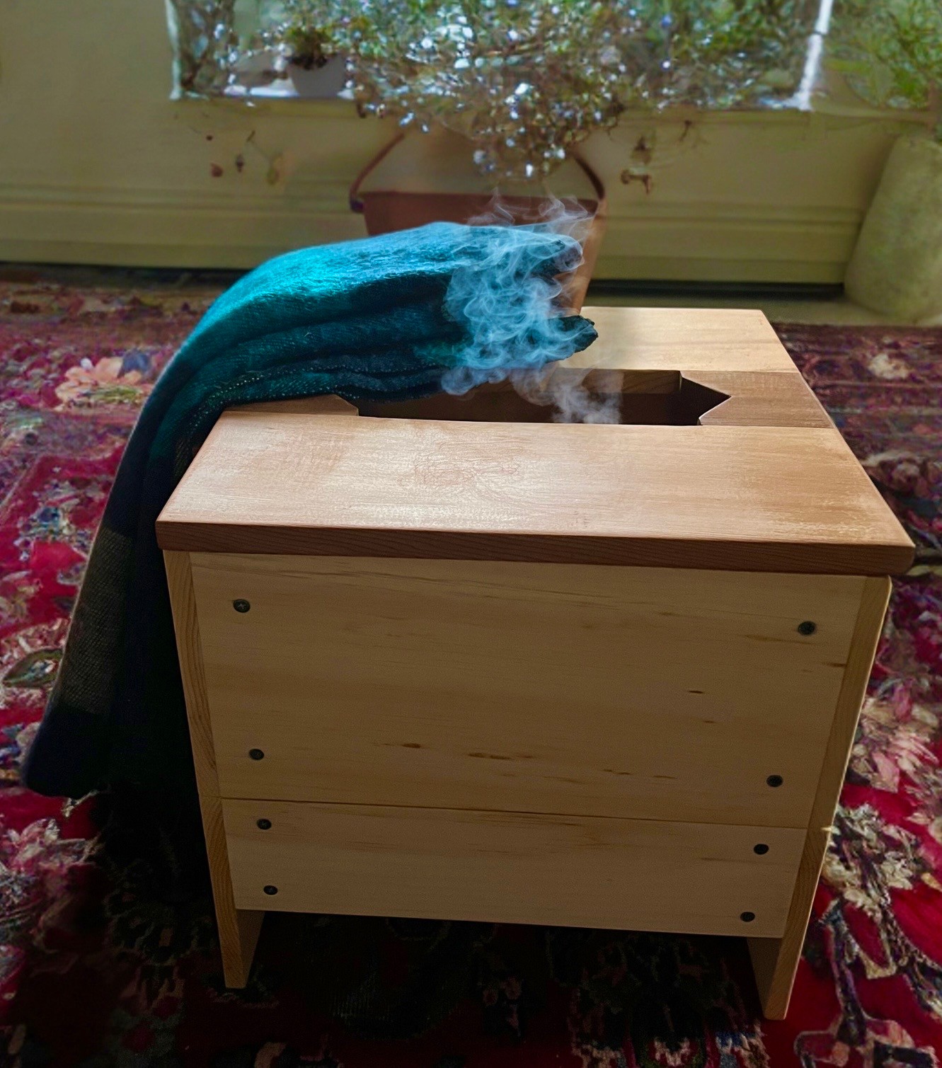 Pelvic Steam Sauna Box with steam rising, a teal blanket draped over it