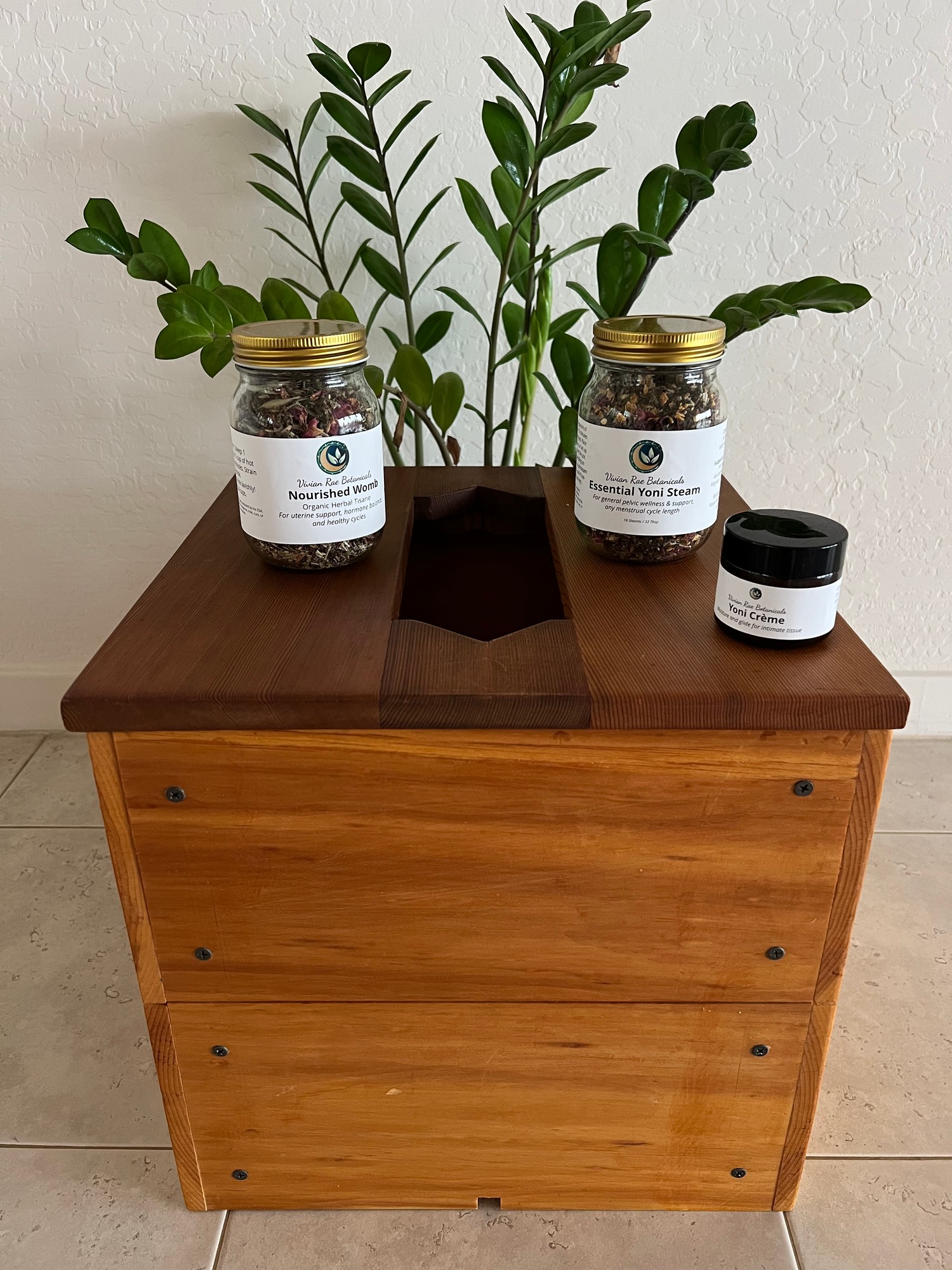 Her wooden steam box with jars of her steam blends on top